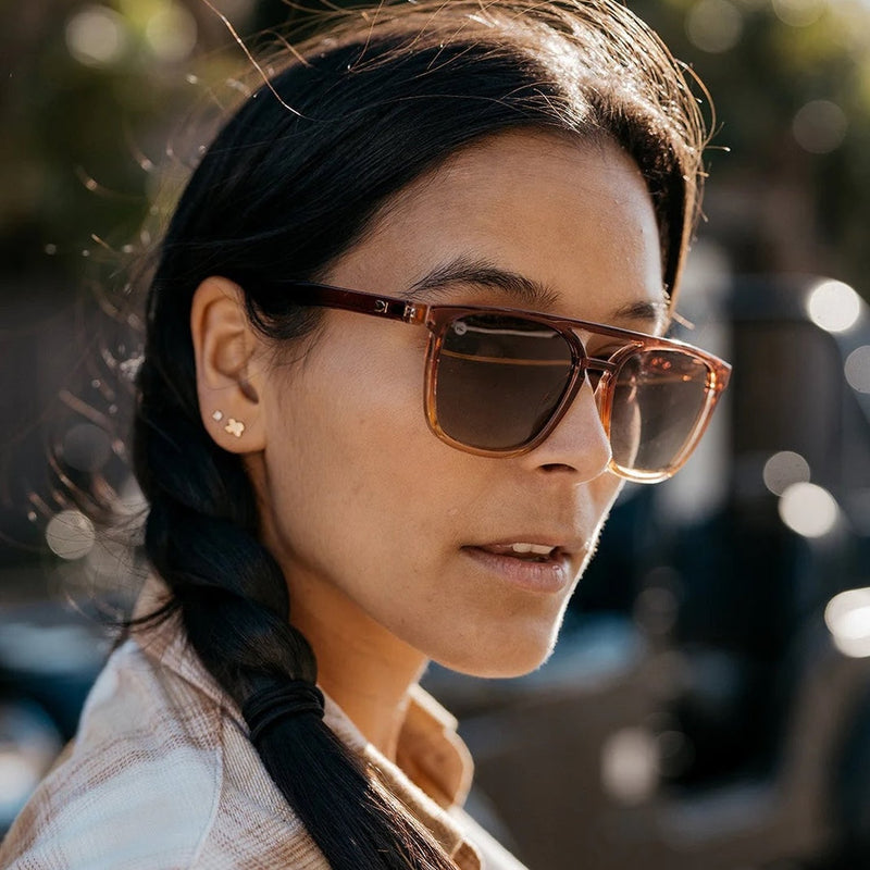 Woman with sunglasses on looking off to the right