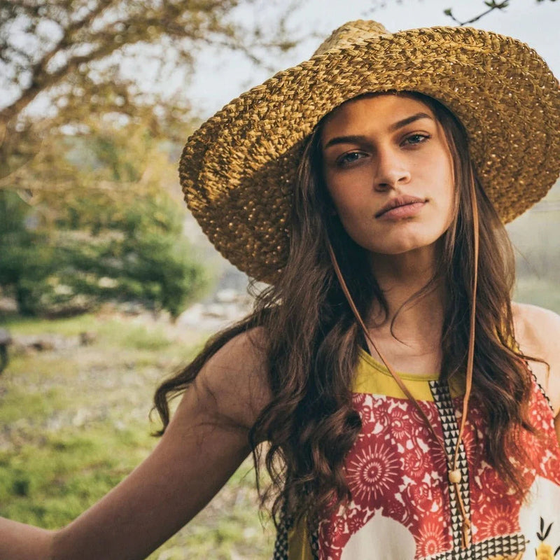 Woman in nature with sun hat on