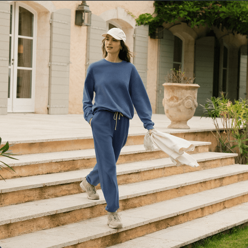Women coming down steps with blue set on and white shawl in hand