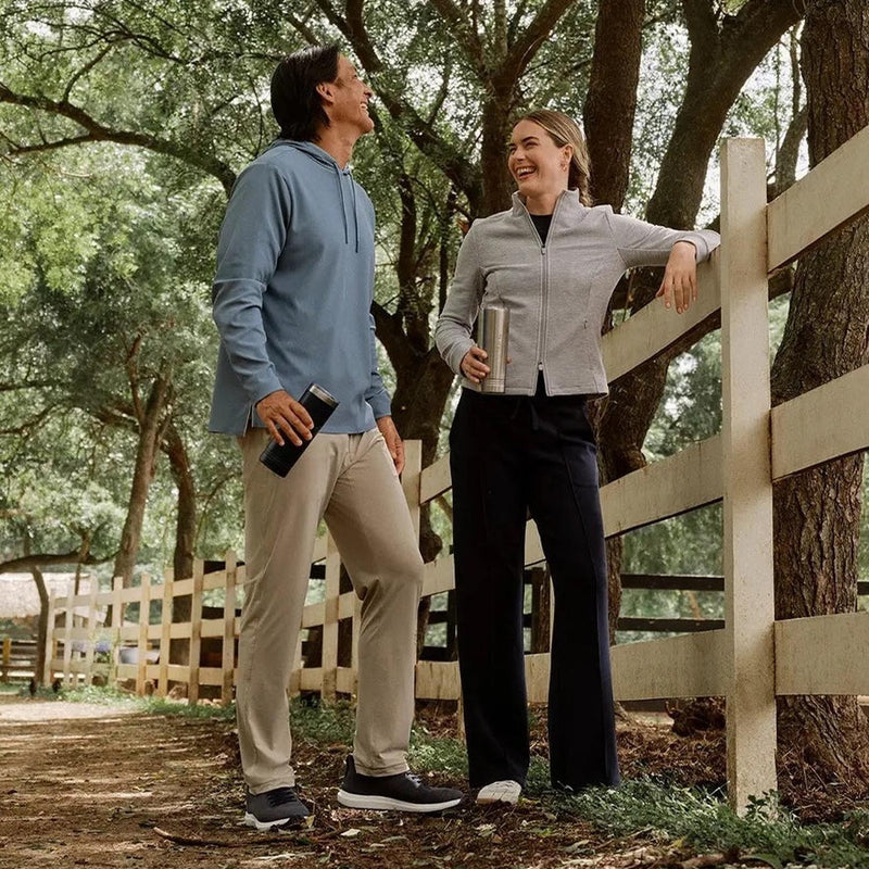Couple having a conversation with emphasis on man with light tan pants.